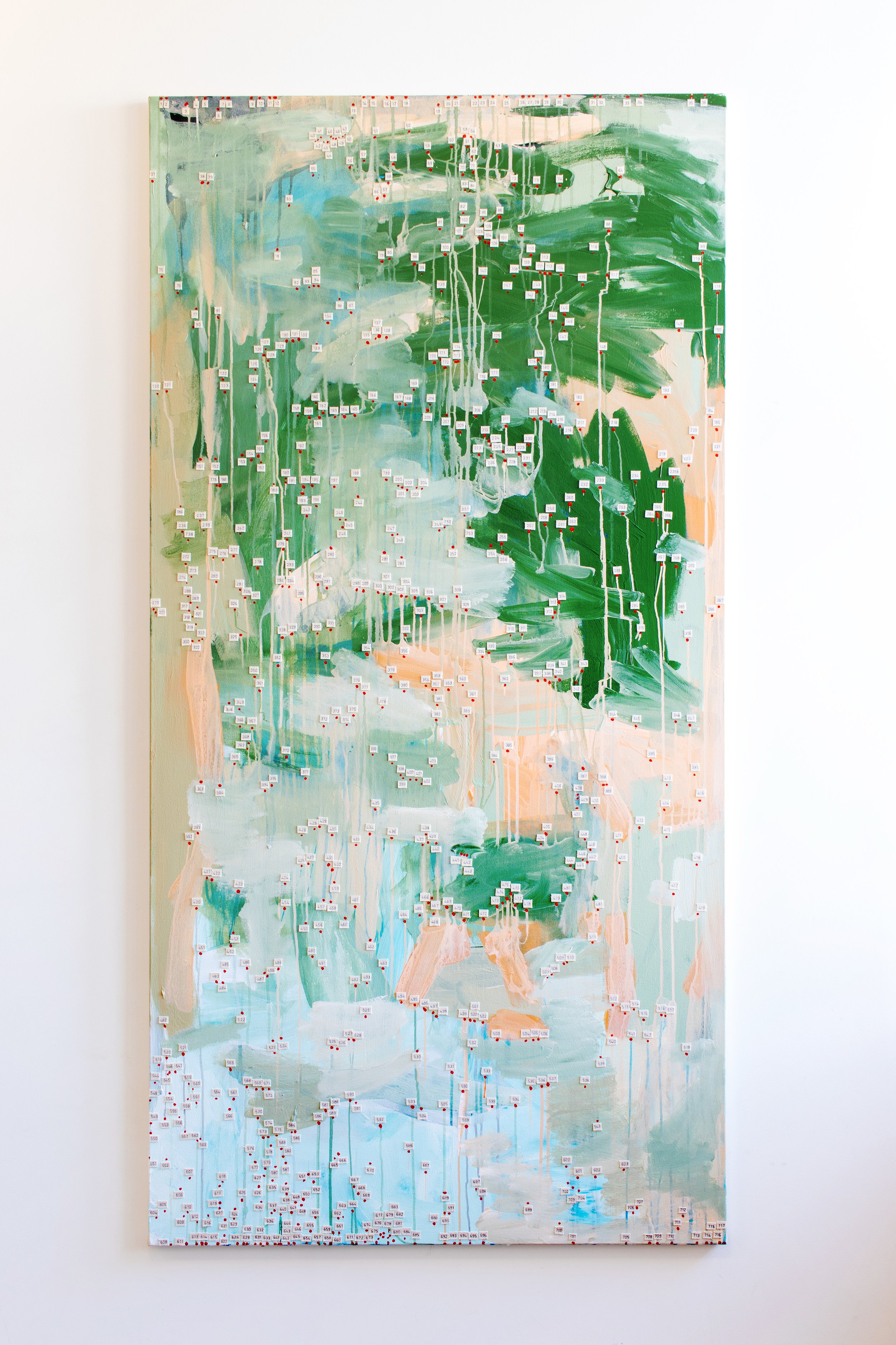 Tall abstract painting in green, pale blue, white, and peach, covered with small numbered labels and thin vertical paint drips.